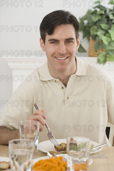 Portrait of man at dinner table.