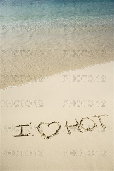 I Love Hot written in sand.