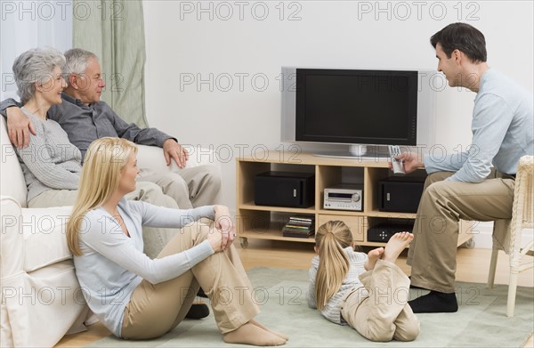 Multi-generational family watching television.