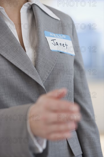 Businesswoman wearing Hello My Name Is sticker.