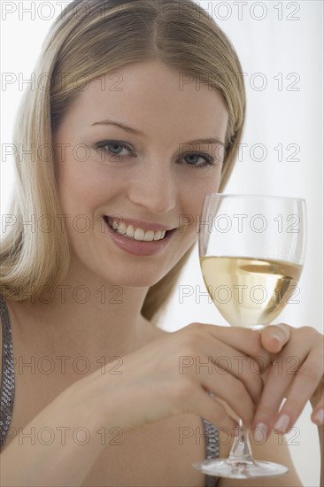 Portrait of woman holding glass of wine.