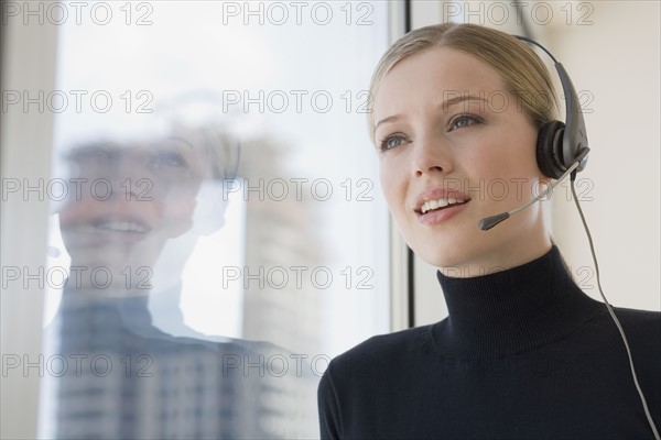 Businesswoman talking on headset.