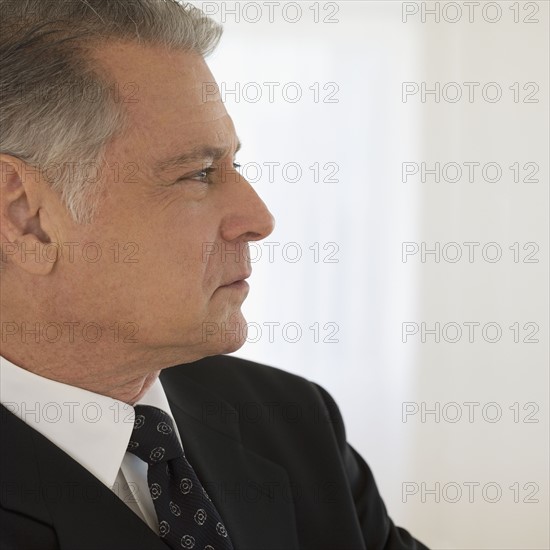 Profile of senior man wearing jacket and necktie.