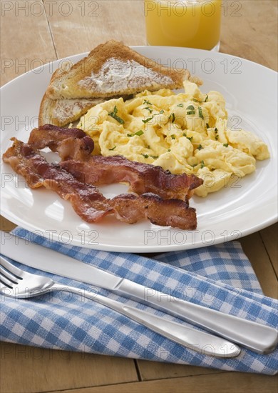 Breakfast plate with eggs and bacon.