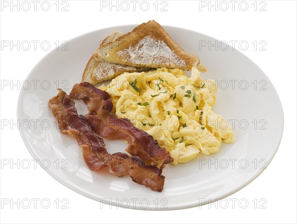 Plate of eggs, toast and bacon.