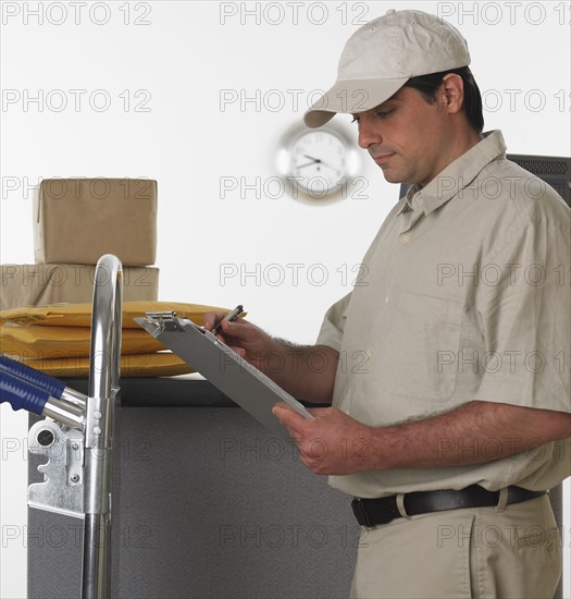 Deliveryman with clipboard and hand truck.