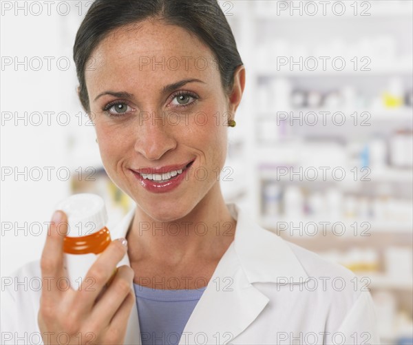 Close up of female pharmacist holding medication.