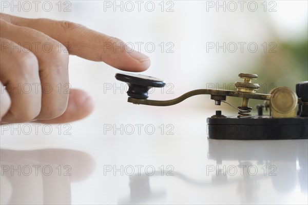 Close up of man using telegraph.