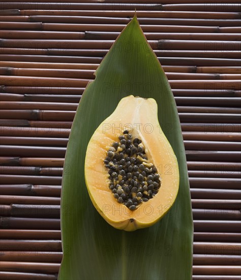 Close up of cut open fruit on leaf.