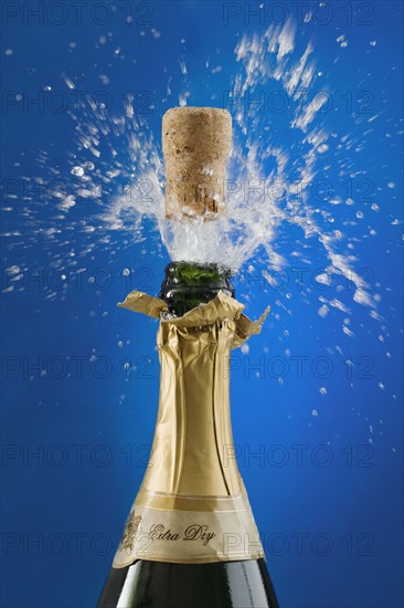 Close up of champagne cork popping.