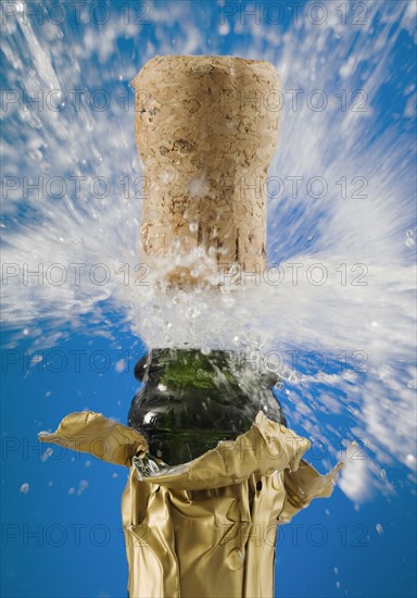 Close up of champagne cork popping.