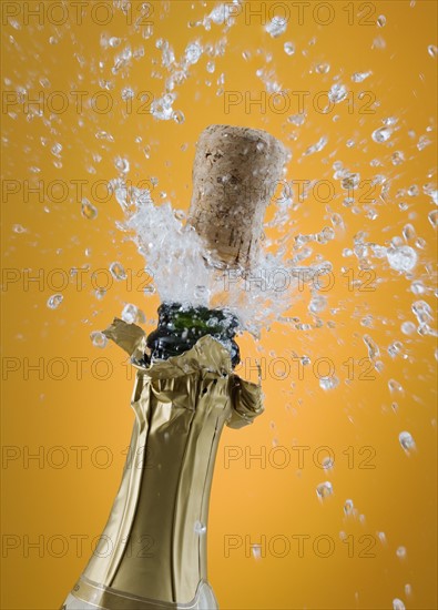 Close up of champagne cork popping.