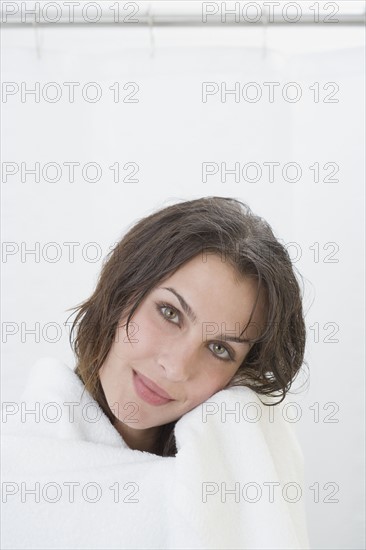 Portrait of woman wrapped in bath towel.