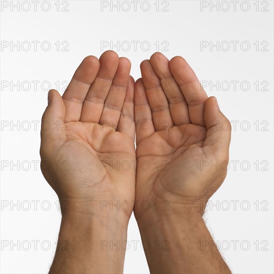 Close up studio shot of man's cupped hands.