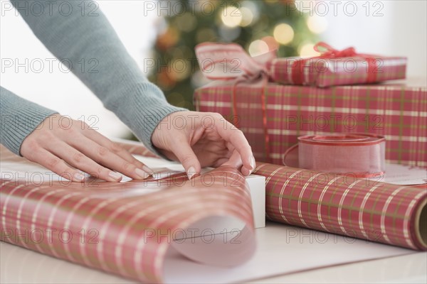 Woman wrapping Christmas gifts.