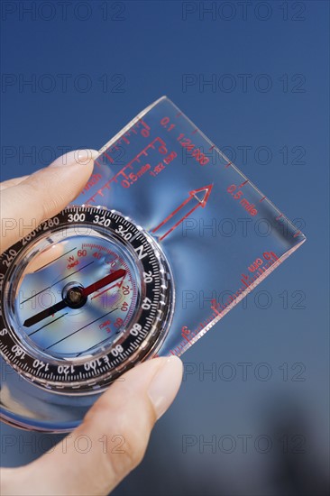 Close up of woman holding compass.