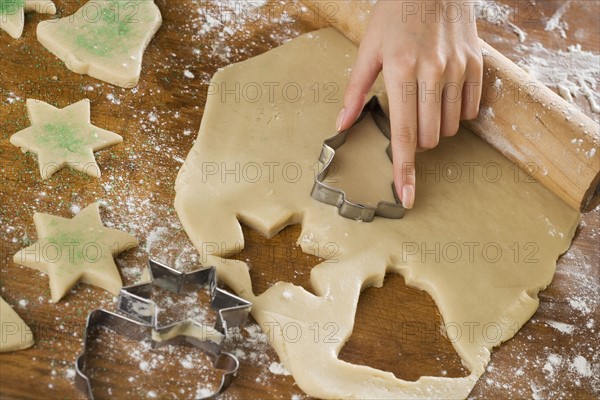 Close up of woman cutting out cookies.