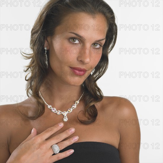 Studio shot of woman wearing fancy jewelry.