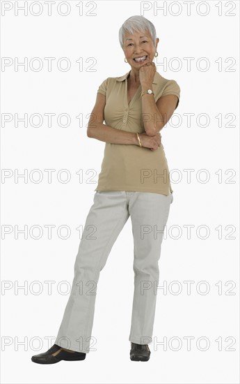 Studio shot of senior woman smiling.