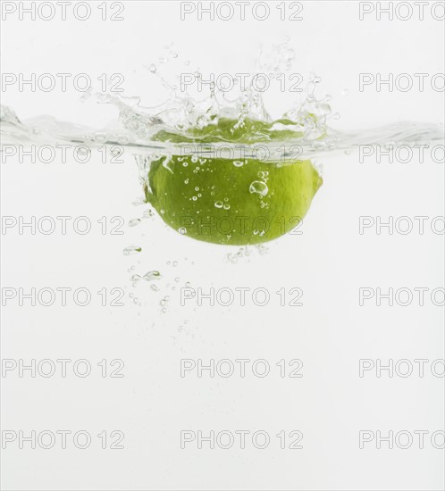 Citrus fruit dropped into water.