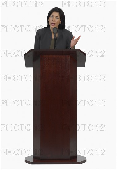 Businesswoman speaking at podium.