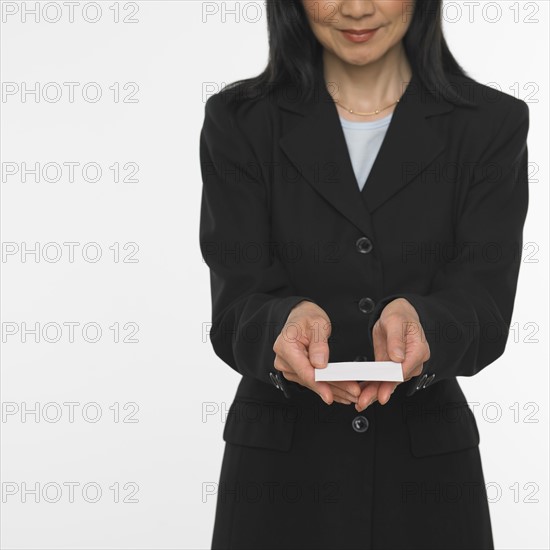 Asian businesswoman offering business card.