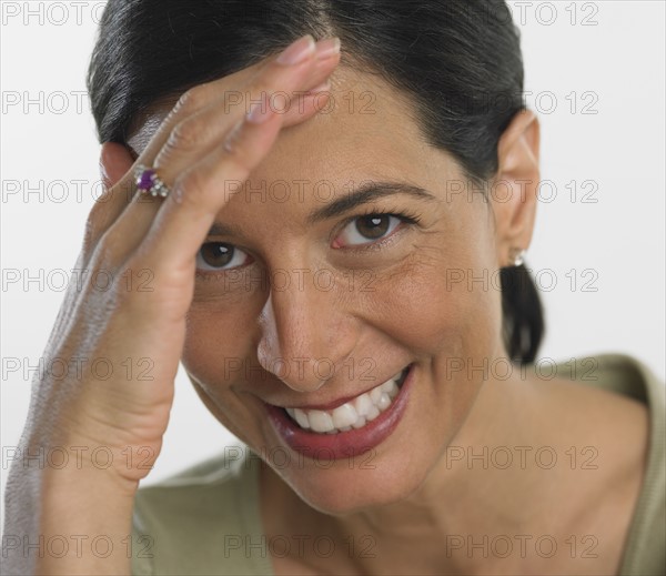 Close up of woman smiling and shading eyes.