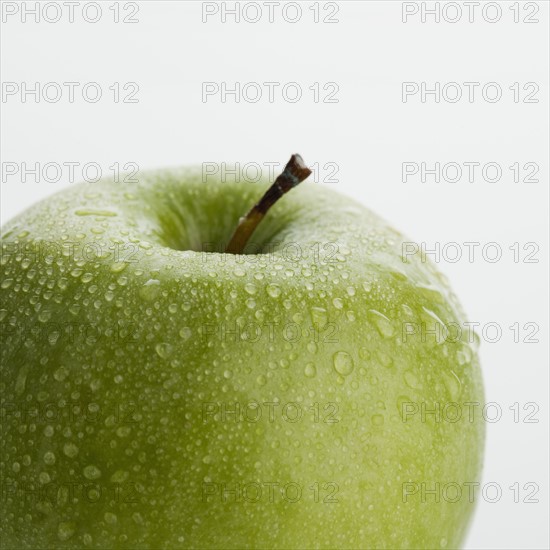 Close up of apple with water droplets.