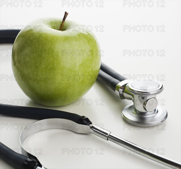 Studio shot of apple and stethoscope.