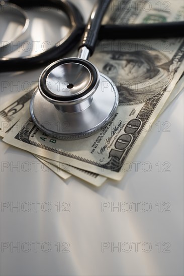 Close up of stethoscope and US dollars.