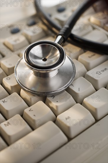 Close up of stethoscope on computer keyboard.