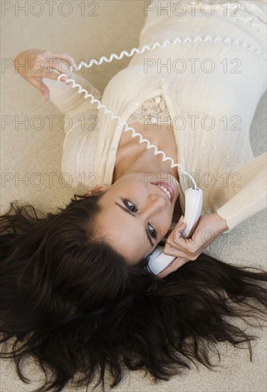 High angle view of woman talking on telephone.