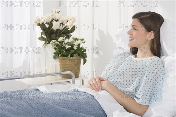 Woman laying in hospital bed.