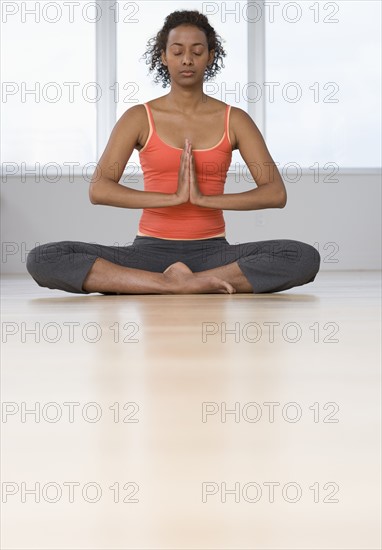 Woman practicing yoga indoors.