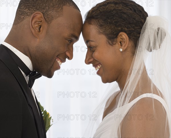 Bride and groom smiling at each other.