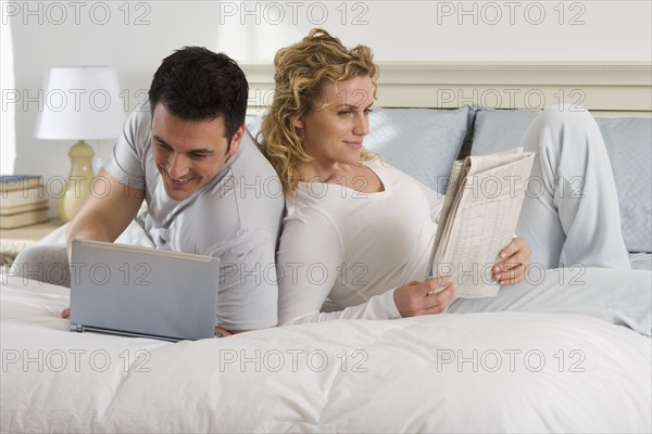 Couple relaxing on bed.