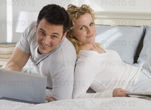 Portrait of couple on bed.