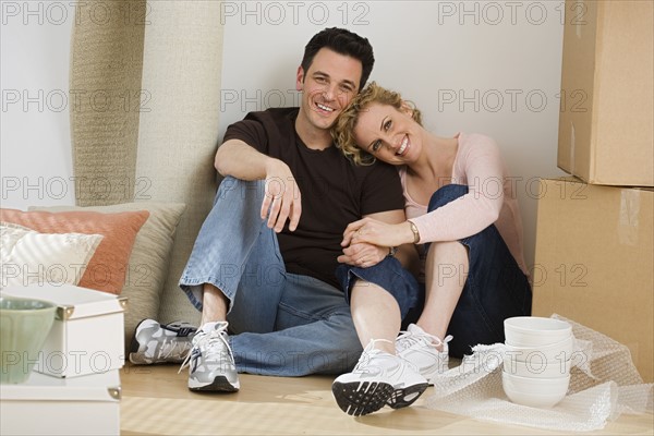 Portrait of couple in new house.