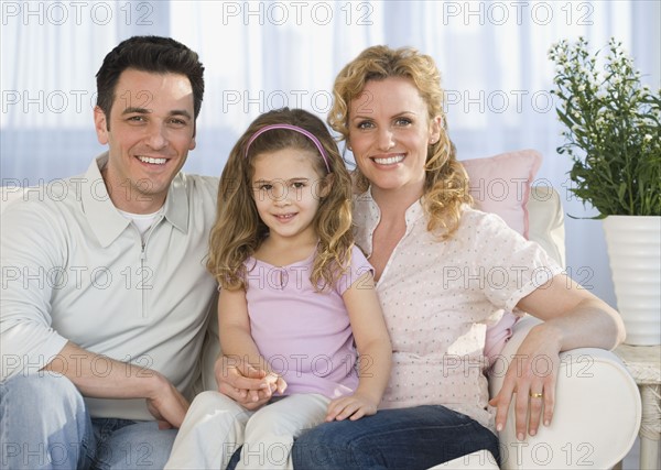 Portrait of family on sofa.