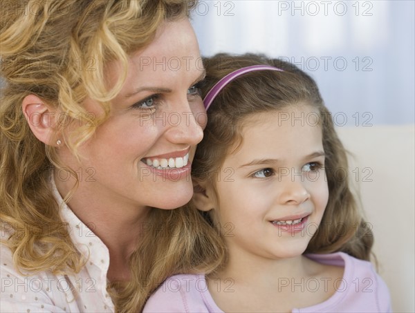 Close up of mother and daughter smiling.