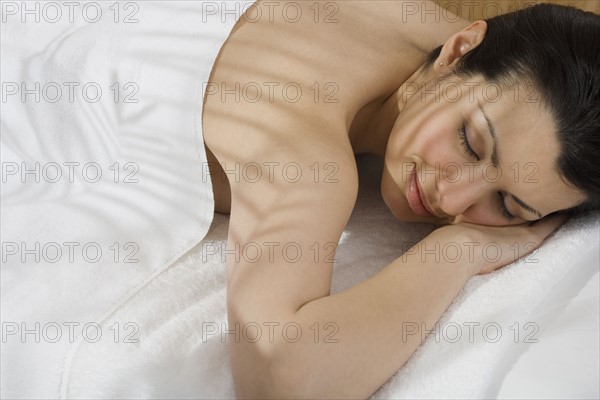 Woman laying on spa table.