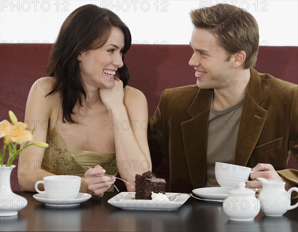 Couple eating dessert at restaurant.