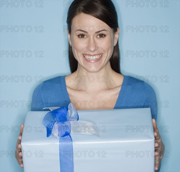 Portrait of woman holding gift.