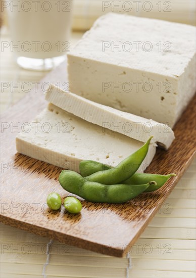 Soybeans and sliced tofu on table.