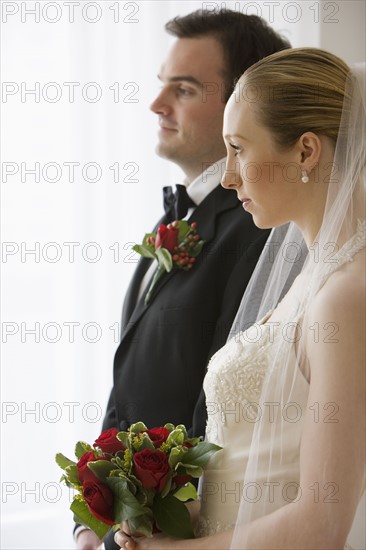 Bride and groom standing next to each other.