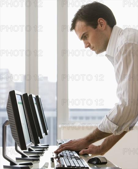 Businessman typing on computer.