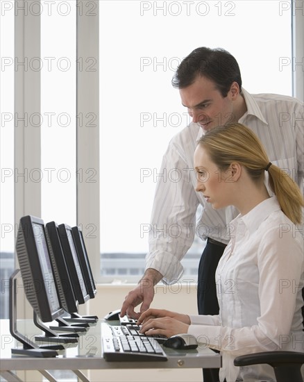 Businesspeople looking at computer.