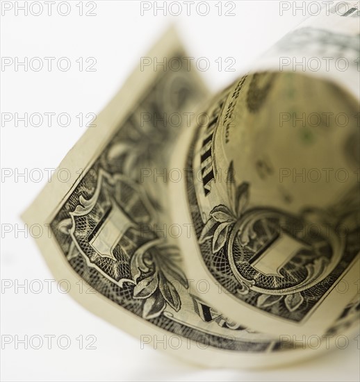Close up of curled dollar bill.