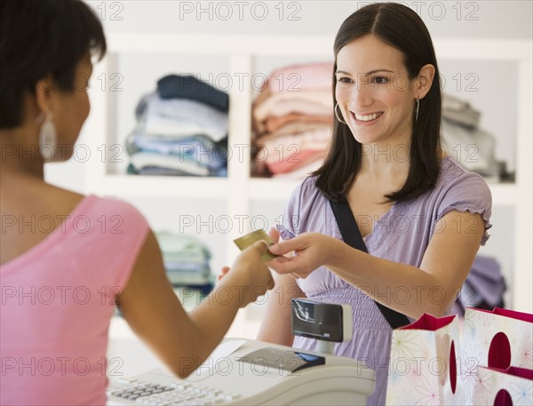 Woman paying at clothing store.