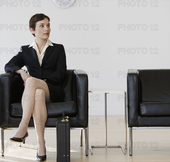 Businesswoman sitting in waiting area.